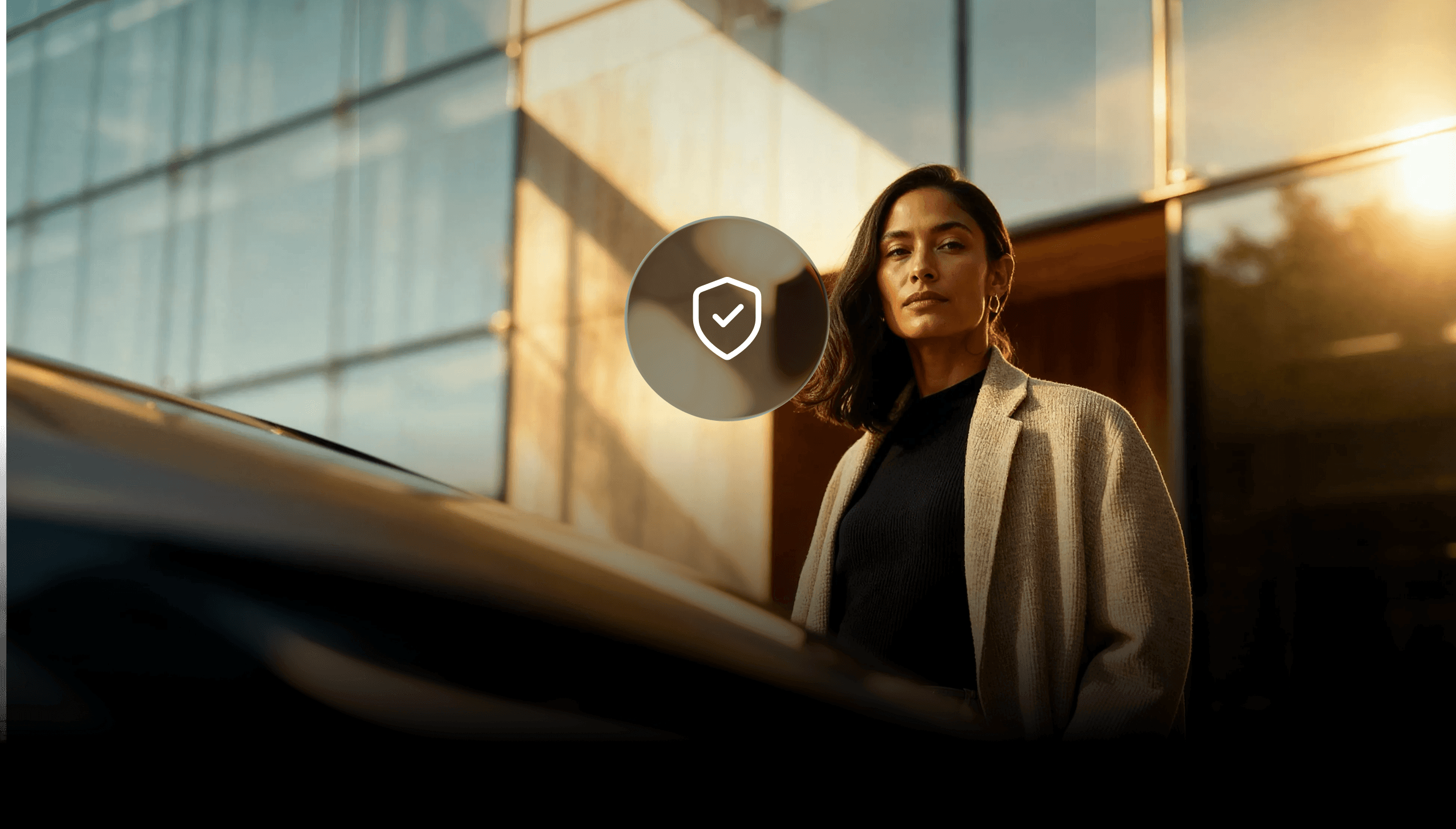 A person outside a modern building with a security shield illustration